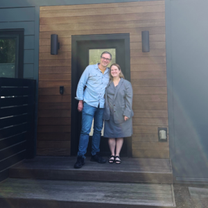 Couple standing in front of their new Portland home